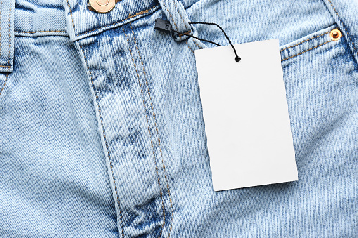 Blank tag on jeans, top view. Space for text