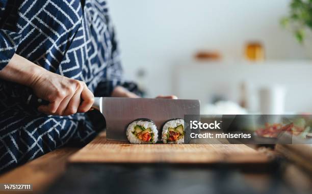 Close Up Photo Of Woman Hands Cutting Sushi Rolls Stock Photo - Download Image Now - Sushi, Kitchen Knife, Making