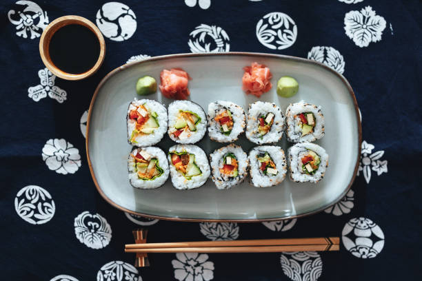 Table Top View Of Sushi Rolls On The Plate With Soy Sauce And Chopsticks