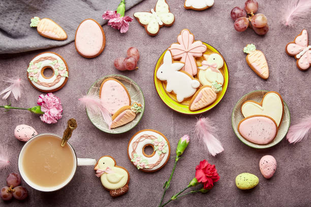 istock Easter aesthetic coffee time flat lay. Decorated glazed cookies, coffee cup, feathers flat lay. Spring stylish background 1475128007