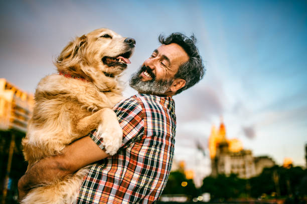 istock Mature man hugs golden retriever 1475128690