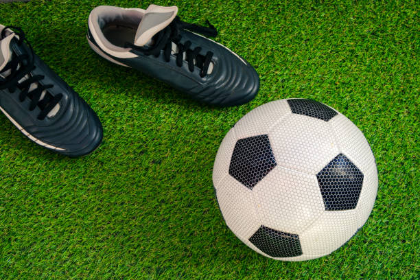 istock Game On: Boots and Ball on the Field 1475129288