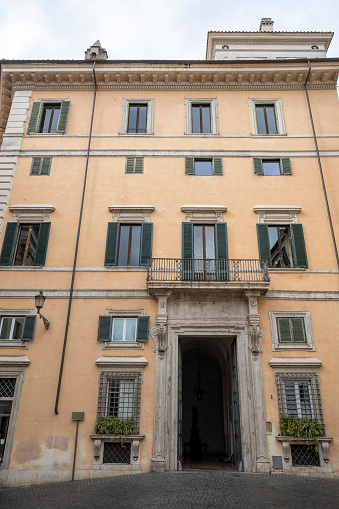 Residential building facade in downtown of Rome, Italy. Mediterranean architecture