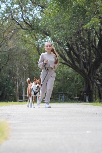 istock Woman walking her dog 1475129859