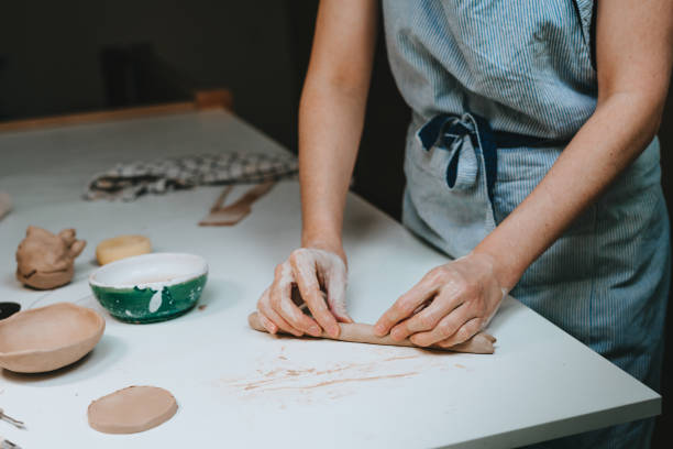 istock Young woman potter working with clay in a workshop 1475132054