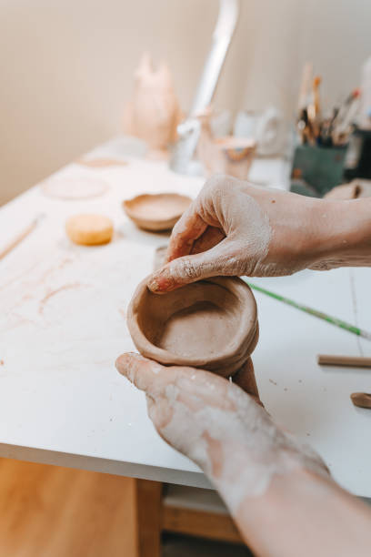 istock Close up of female hands making a mug 1475132096