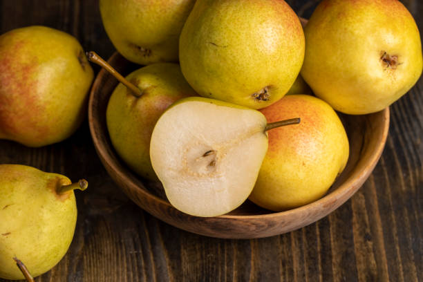 istock A yellow ripe pear with a red side on the table 1475134750