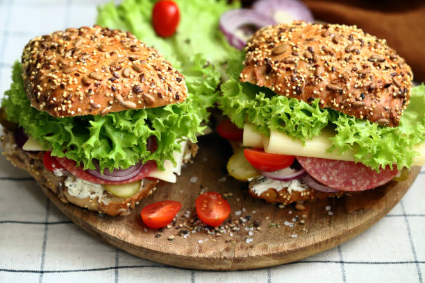 istock Appetizing sandwich with salami, cheese and vegetables. 1475137526