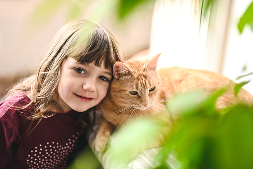 cute child in love with her cat.