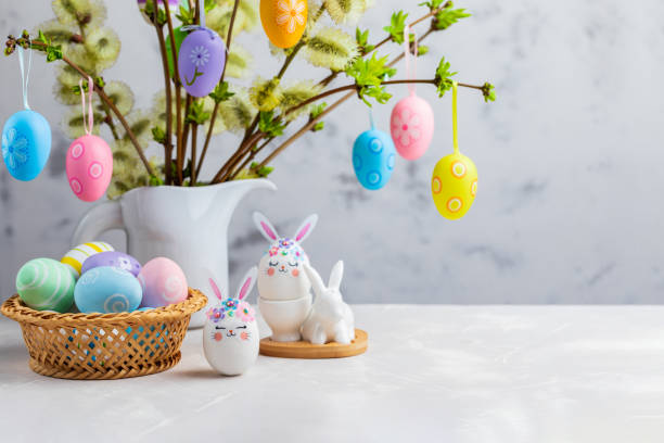 istock Easter composition with crafted Easter bunny, colorful eggs and flowering willow decorated with Easter eggs. 1475138520