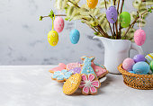 Easter composition with homemade Easter gingerbread cookies and colorful Easter eggs.