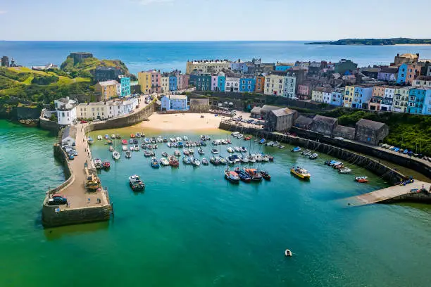 Aerial view of brightly colored buildings around a small harbour (Tenby, Pembrokeshire, Wales)