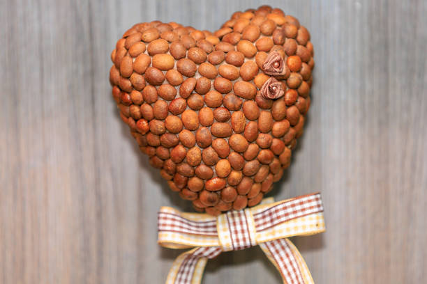 Symbolic heart made of coffee beans. Background with selective focus and copy space for text
