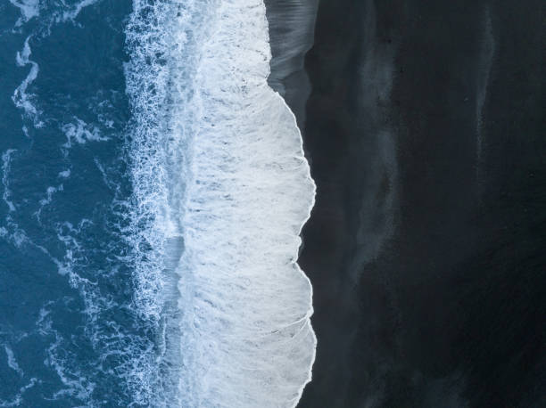istock Waves crashing on black sand beach in Vik, Iceland 1475143155