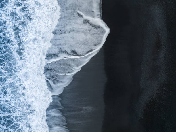 istock Waves crashing on black sand beach in Vik, Iceland 1475143158