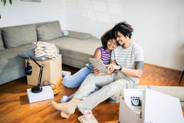 istock Young couple relaxing at home and using a digital tablet 1475149181