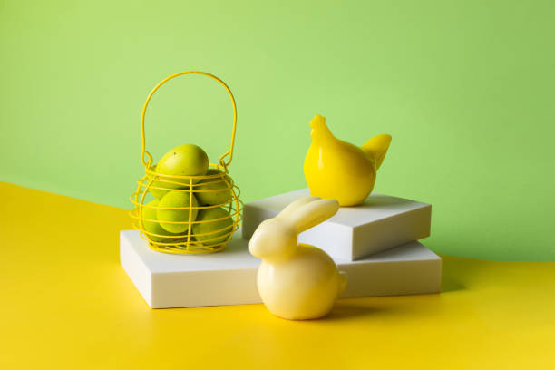 istock Bunny ,hen and ybasket with eggs on white podium at green yellow spring background. Modern Easter still life image 1475150376