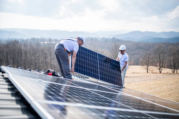 istock Caucasian men installing panels on roof. 1475150422