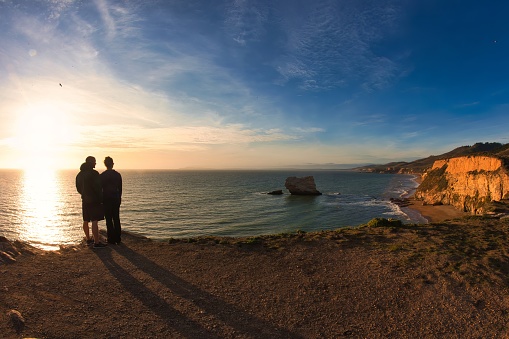 Bodega bay, United States - November 12 2011 : cliffs on the pacific ocean near Point Reyes in the national park with a couple of lovers in the sunset