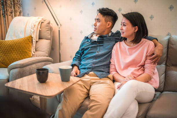 istock Young Asian Parents Enjoying A Peaceful Afternoon At Home 1475152255