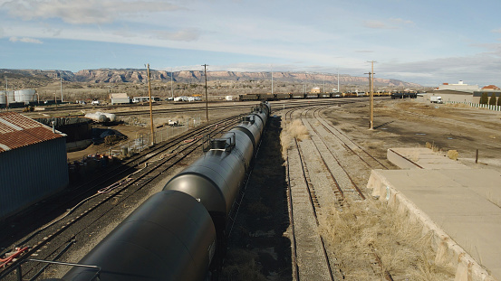 Railroad Car Oil Tanks Industrial Gas and Oil Equipment in the Western USA Industrial Crude Oil and Fuel Tanker Cars on Track Near Storage Transfer Facility on Train Tracks Photo Series - Matching Video in Portfolio