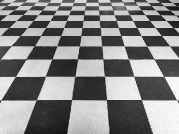 istock Black and white tiled floor symmetrical with a grid texture in front view for a permanent tiled floor background. black and white square Made of ceramic material for flooring 1475159553