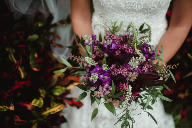 istock Bride holding purple wedding bouquet 1475162750