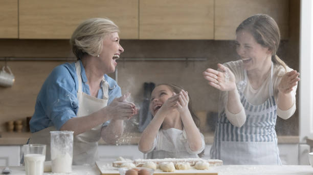 istock Cheerful overjoyed kid, mother and grandma having fun in kitchen 1475162884