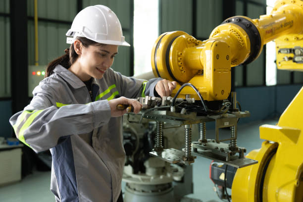 istock Female engineer using wrench  adjusting machine in factory 1475163187