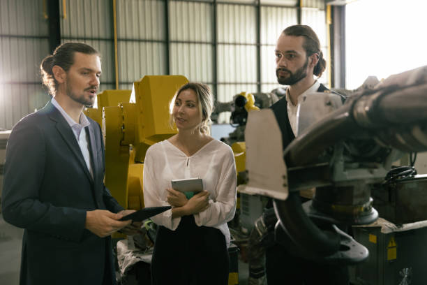 istock Businessman and secretary talking about trading machine in warehouse 1475163201