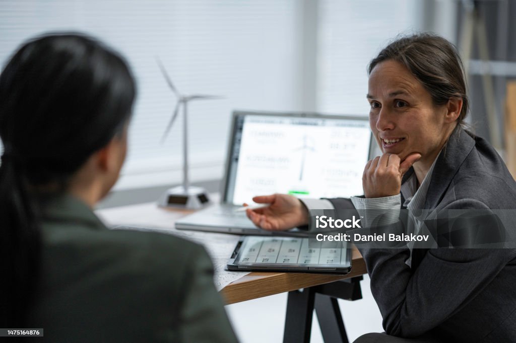 Wind energy engineers team working in office. Alternative renewable energy systems. Carbon neutrality and sustainable green energy. Sustainable Resources Stock Photo