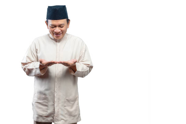 istock Asian Muslim man with open palm hand showing something 1475165008