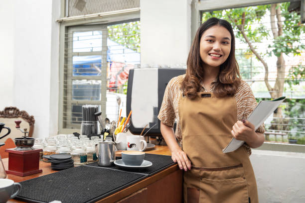 istock Asian woman barista holding menu book 1475165123