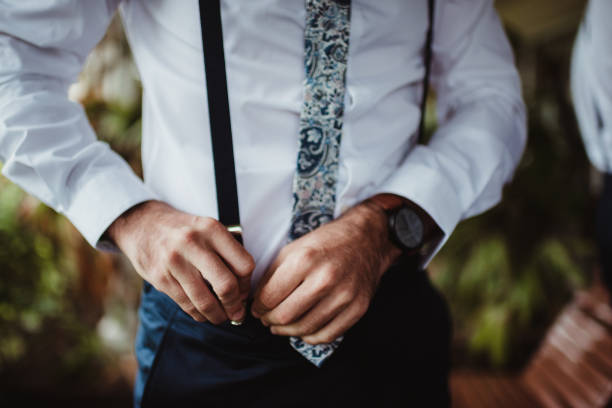istock Man putting on suspenders 1475165204