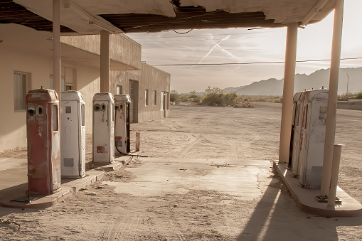 Abandoned gas station on Route 66 at sunset.