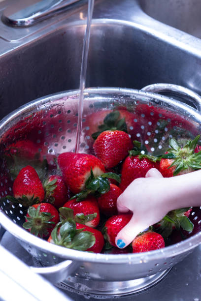 istock Child Washing Strawberries 1475168482