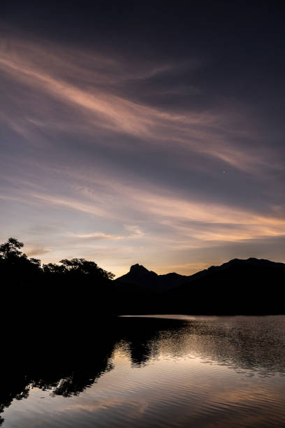 istock Beautiful sunset with orange clouds over rainforest lake 1475169592