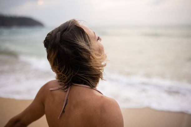 istock Woman enjoying by the sea 1475169847