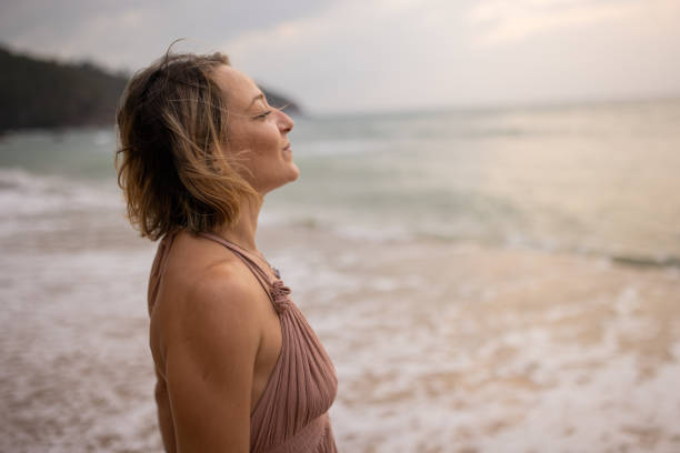 istock Woman enjoying by the sea 1475169890