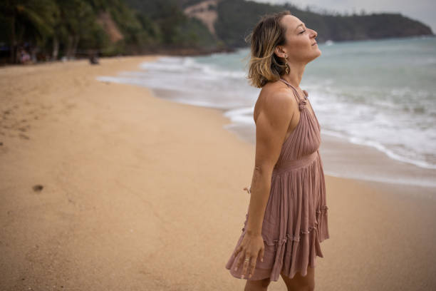 istock Woman enjoying on the beach 1475171051