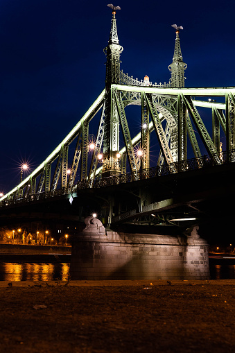 Liberty Bridge in Budapest at night. Bridge crosses the Danubius river in Budapest, Hungary