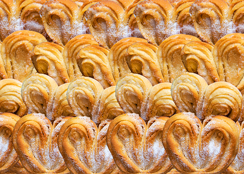 Puff pastry cookies palmier or elephant ears, caramelized and crunchy pastry. White background, top view.