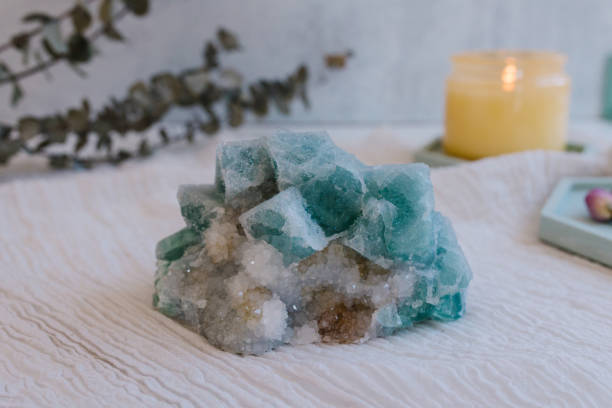 istock Blue and white sparkly quartz with yellow candle and eucalyptus 1475171760
