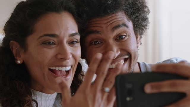 happy couple video chatting on smartphone beautiful woman showing wedding ring enjoying romantic celebration