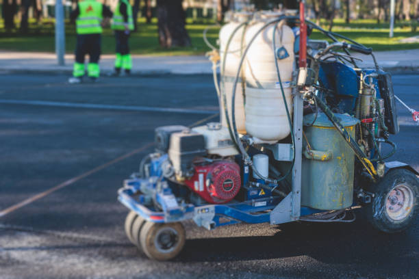 istock Process of making new road surface markings with a line striping machine, workers improve city infrastructure, demarcation marking of pedestrian crossing with a hot melted paint on asphalt pavement 1475179714