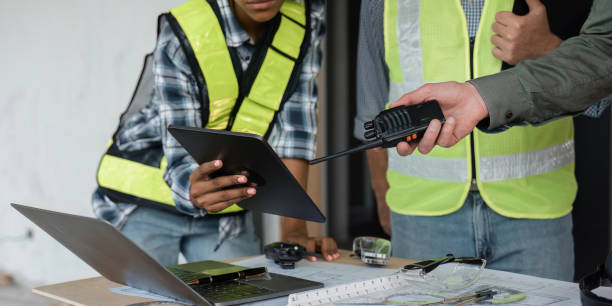 istock engineer working in office with blueprints , walkie talkie, tablet , laptop, inspection in workplace for architectural plan, construction project ,Business construction 1475183590