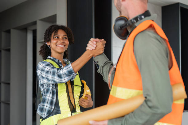 istock Engineer team shake hands arm wrestling builder building renovation in site, Construction contractors building a new home 1475184812