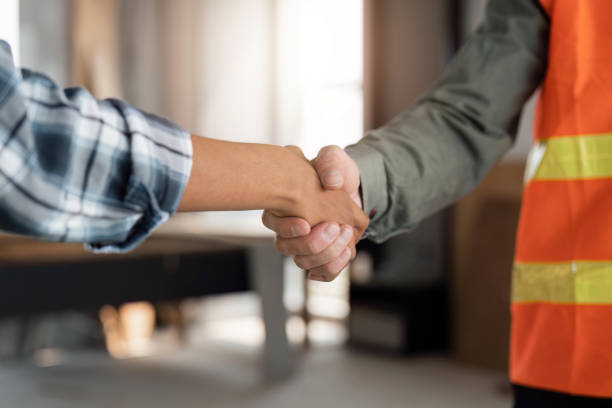 istock Close up hand of young engineer handshake with partnership after agreement to work together at the site, workplace , business success concept. 1475184841