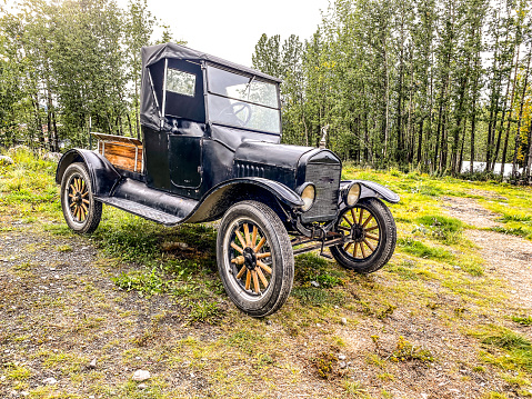 August 28, 2022, McCarthy, Alaska. An antique car sits on a grassy area as a reminder of days gone by.