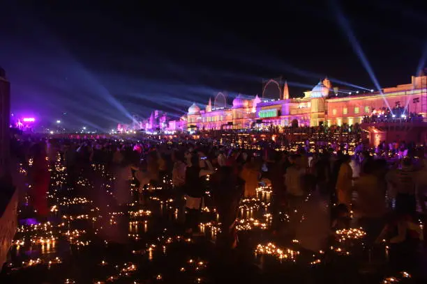 Hindu devotees or people are celebrating Deepotsav in Ram Ki Paidi, Ayodhya on 23 October 2022 Deepawali or Diwali in Ayodhya, Faizabaad. Beautiful decoration of laser light show and oil lamp flames. Diwali is a festival of happiness, joy and celebration and culture of Hinduism. Ram Mandir in Ayodhya.